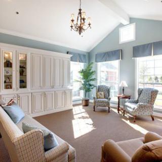 A bright and spacious living room with elegant furnishings and ample natural light.