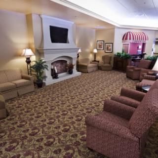 A cozy lobby area featuring comfortable seating and a warm fireplace, perfect for relaxation.