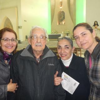 A group of people posing happily together inside a church.
