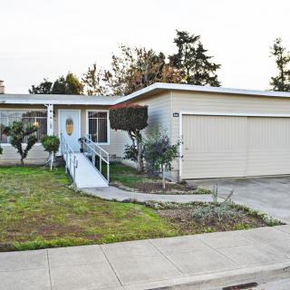A suburban house with a ramp leading to the front door and a two-car garage.