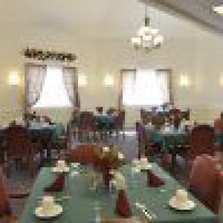 Interior view of a restaurant dining area with neatly arranged tables and chairs.