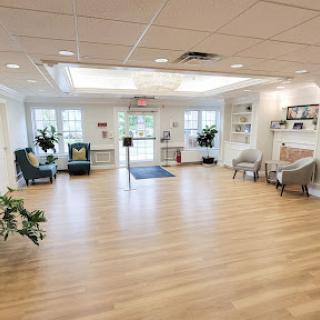A spacious and well-lit lobby featuring modern seating arrangements and greenery.