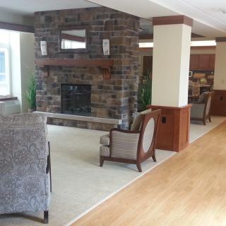 A cozy living area with a stone fireplace and comfortable seating.
