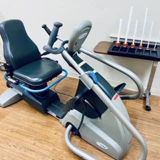 A sleek elliptical machine designed for an effective cardio workout, accompanied by a set of fitness tools.