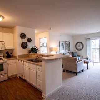 A bright and inviting open-concept living space featuring a modern kitchen and cozy living area.