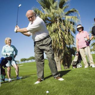 A group of seniors enjoying a sunny day on the golf course.