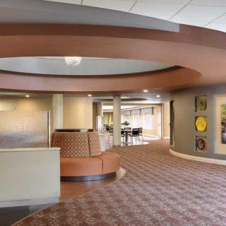 A modern lobby with stylish interior design, featuring a seating area and contemporary decor.