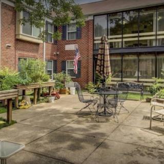 A cozy courtyard with outdoor seating and lush greenery.