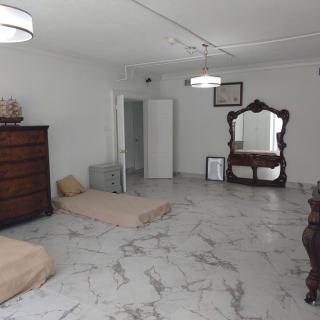 A minimalist room with mattresses on the floor and wooden furniture.