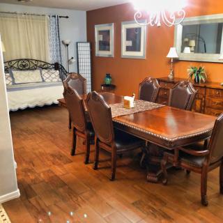 A cozy dining room with a wooden table and chairs, complemented by warm-toned walls and elegant decor.