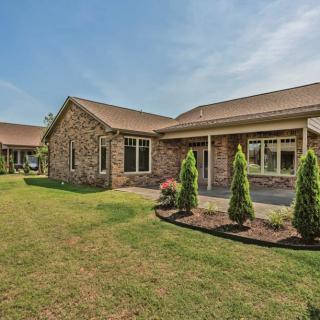 Beautiful brick house with well-maintained landscaping and a green lawn.