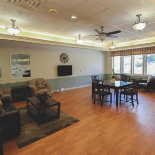 A cozy living room with comfortable seating, a television, and ample natural light.