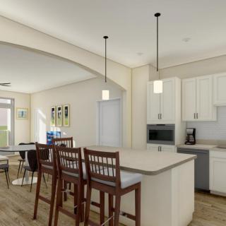Modern kitchen interior with an island and dining area.
