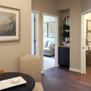 A cozy interior with a dining table, hallway, and glimpses of living areas.