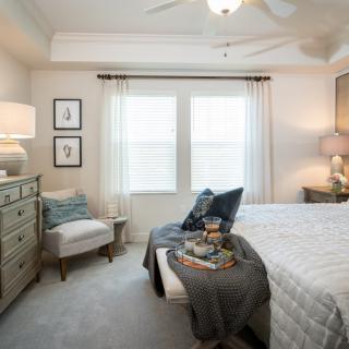 A cozy and modern bedroom with tasteful decor and ample natural lighting.