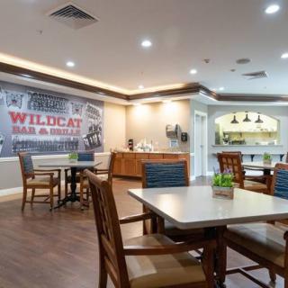 An indoor dining area with tables and chairs, featuring a casual atmosphere and decorative elements.