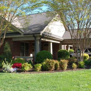 A well-maintained house with lush landscaping and a green lawn.