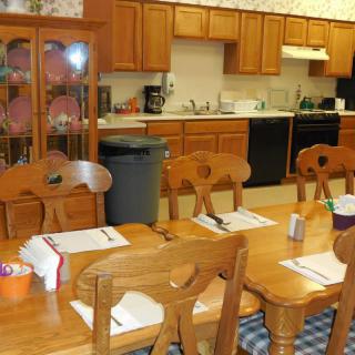 A cozy kitchen and dining area featuring wooden furniture and cabinets.
