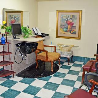 A cozy hair salon interior with a waiting area and reception desk.