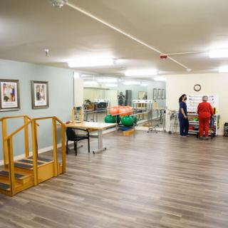 A rehabilitation room equipped with exercise tools and a staircase for physical therapy.