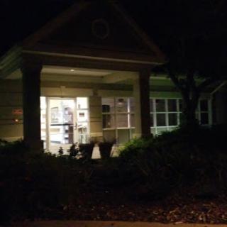 A well-lit entrance of a building during the night.