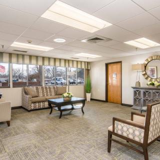A well-lit lobby area with comfortable seating and tasteful decor.