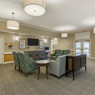 A cozy and well-furnished living area with comfortable seating and modern lighting fixtures.