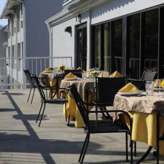 Outdoor patio seating at a restaurant with neatly arranged tables and chairs.