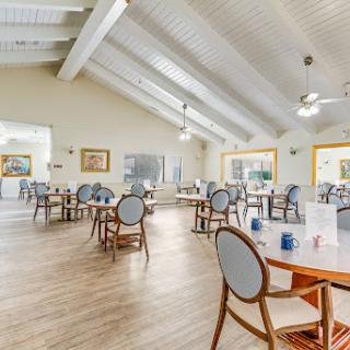 A spacious and modern dining area featuring elegant furniture and ample natural light.