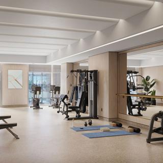 A modern gym with various exercise equipment and a spacious workout area.