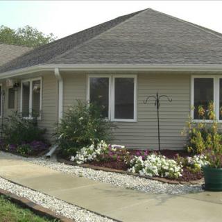 A suburban house with a well-maintained garden and pathway.