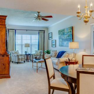 A well-decorated living room featuring classic furniture and a chandelier.