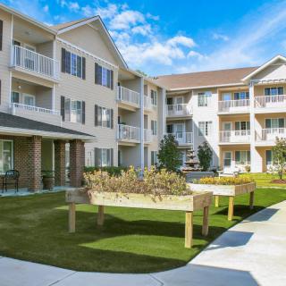 A modern residential apartment building with landscaped outdoor space.