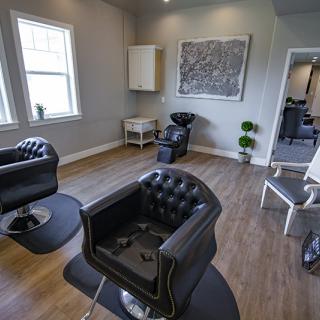 A modern hair salon interior with stylish chairs and sleek decor.