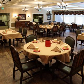 A well-arranged restaurant dining area with neatly set tables and chairs.