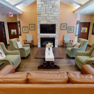 A cozy living room with a fireplace and comfortable seating.