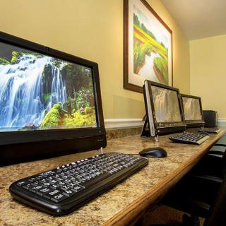 A row of computer workstations with waterfall images displayed on the monitors.