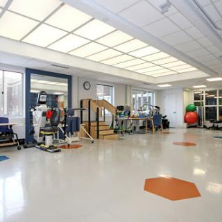 A spacious and well-equipped physical therapy room designed for rehabilitation exercises.