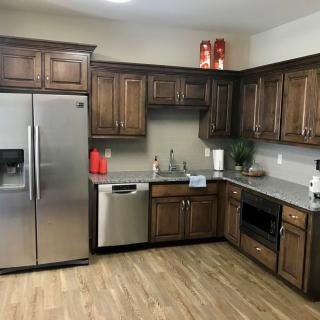 A modern kitchen with wooden cabinets and stainless steel appliances.