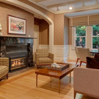 A cozy living room with a fireplace and comfortable seating arrangement.