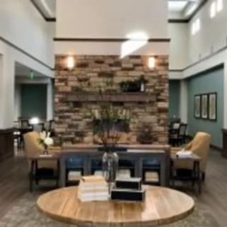A modern lobby with a stone accent wall and comfortable seating area.