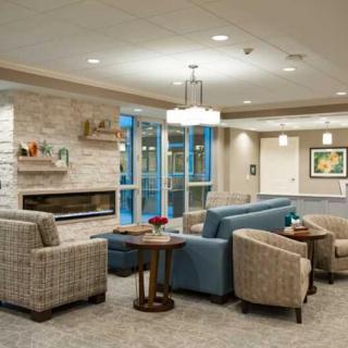 A modern lobby with comfortable seating and a fireplace.