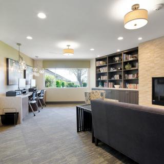 A modern living room with a dual office space and built-in bookshelves.