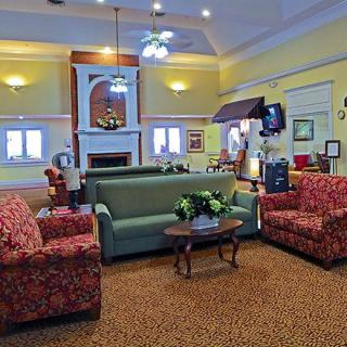 A cozy living room with colorful furniture and warm lighting.