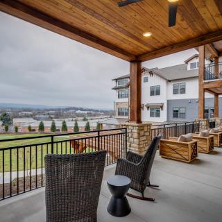 A modern outdoor patio with comfortable seating and a scenic view.