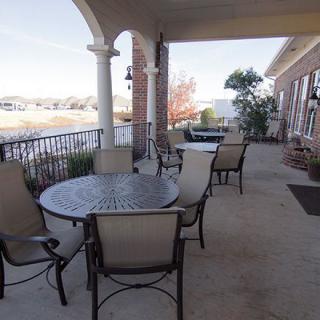 A covered patio with outdoor seating and a view.