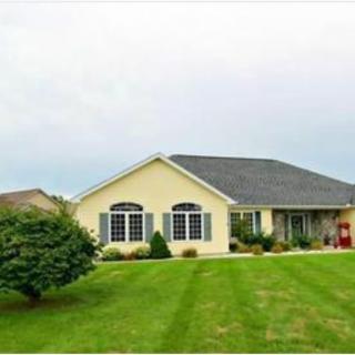 A single-story suburban house with a well-maintained lawn.