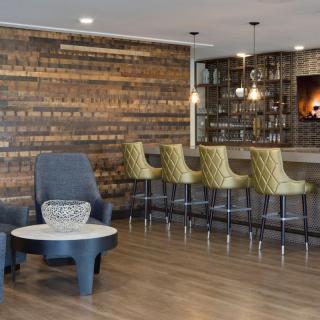 A modern bar interior with wooden accents and stylish seating.