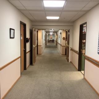 A long office hallway with doors on either side.