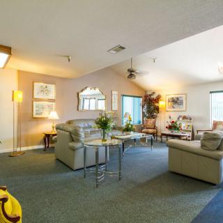 A spacious living room featuring comfortable sofas, a coffee table, and elegant decor.
